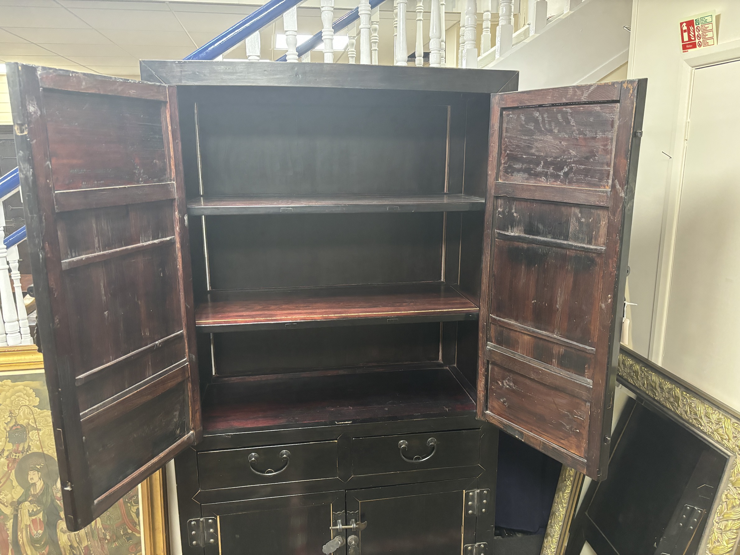 A Chinese lacquered side cabinet, width 109cm, depth 50cm, height 203cm